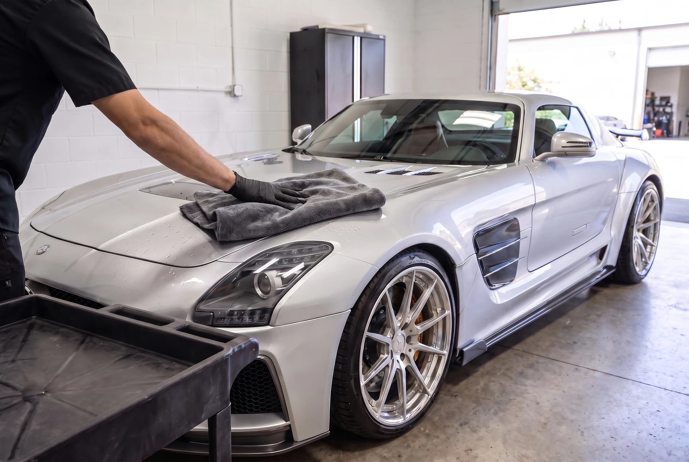 Drying the clean, rinsed silver SLS with a microfiber towel