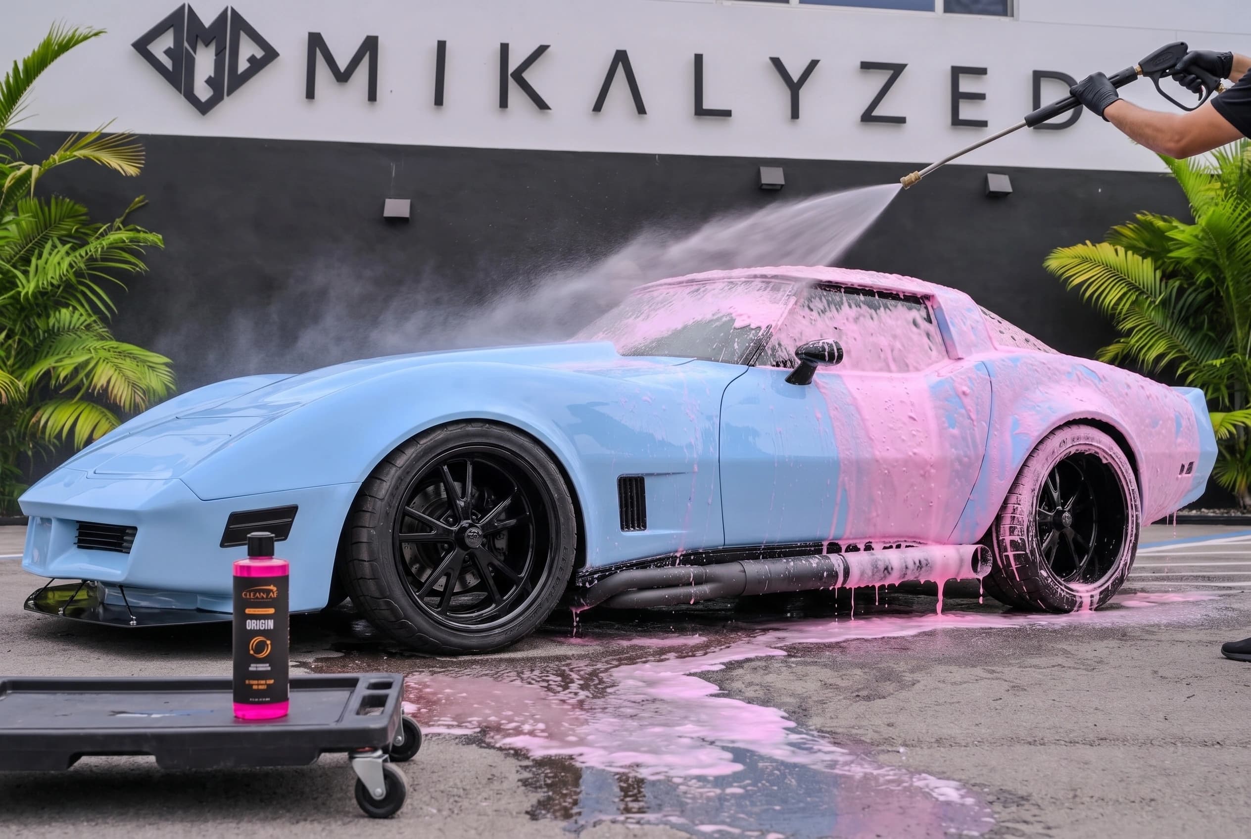 Clear water rinsing foam from the light-blue Corvette