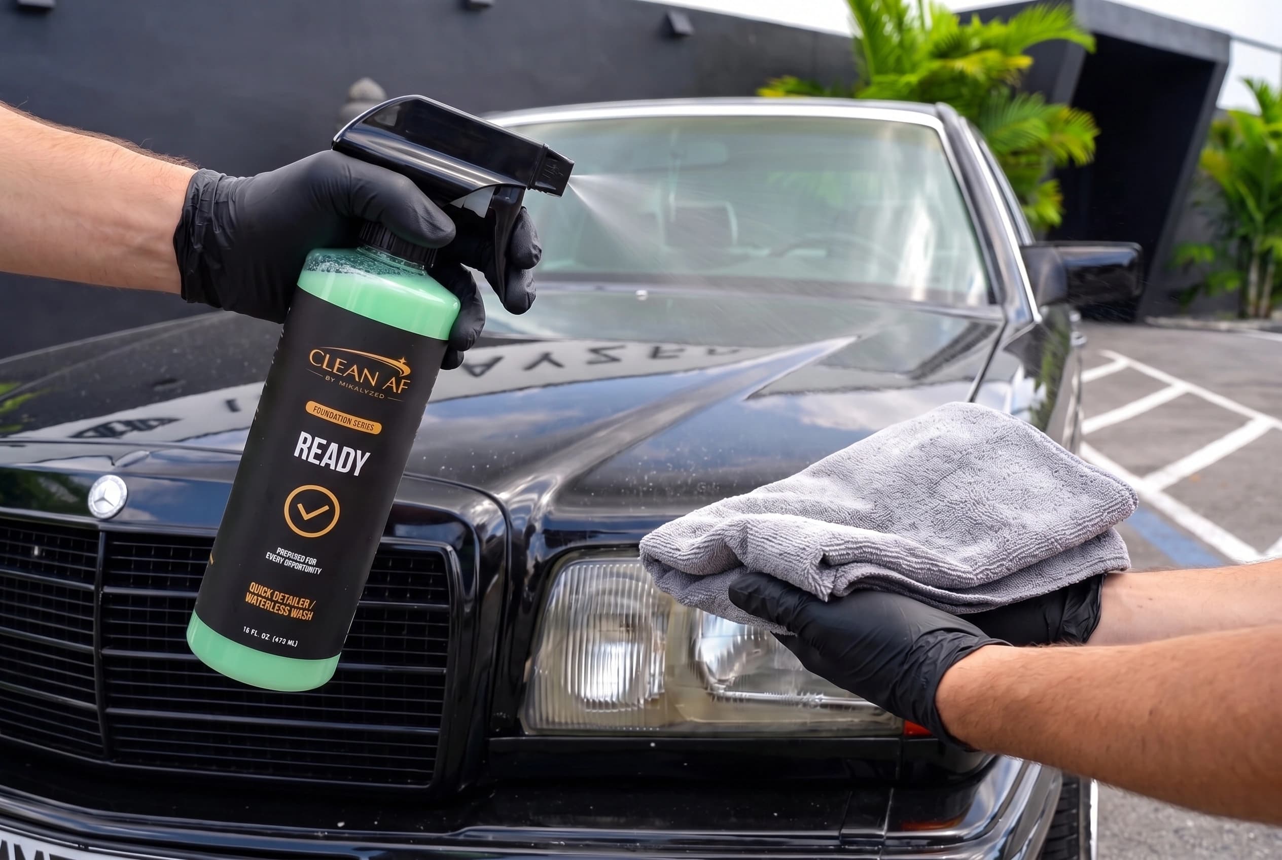 A fine mist applied to a microfiber towel above the black Mercedes hood, with READY beside the car